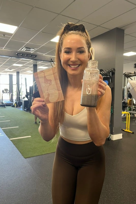 Suna drinker savoring a bold protein latte blend with Assam black tea and marine collagen.